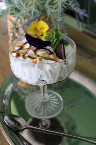 a dessert in a glass bowl on a glass table at Hotel Ariana in Tăşnad