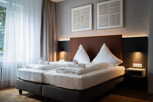 Postel nebo postele na pokoji v ubytování JUNIK Apartments Oberhausen