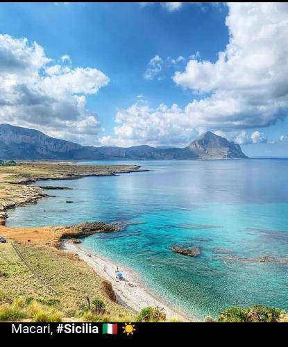 a large body of water with mountains in the background at Cofanomare in Custonaci