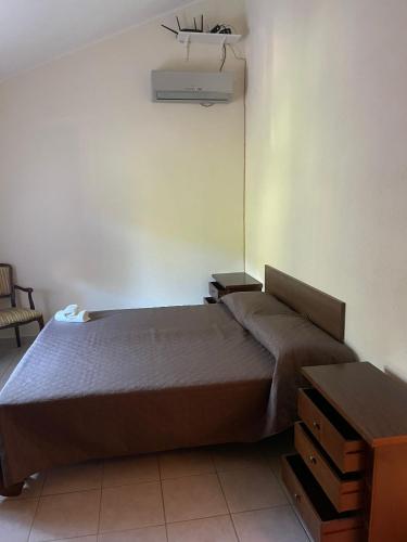 a bedroom with a bed in a room at Palazzo 1815 in Papasidero