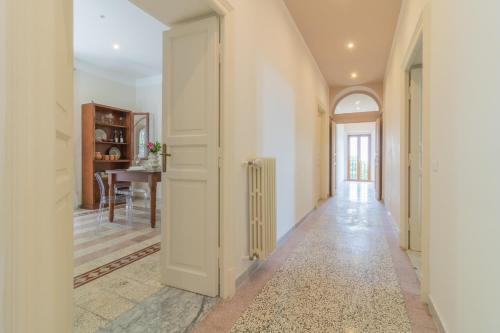 a hallway with a white door and a table at Lake Lovers Lodge in Montefiascone
