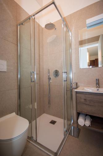 a bathroom with a shower and a toilet and a sink at Tiny House in Bibione