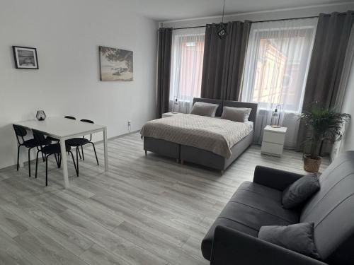 a living room with a bed and a table at Apartamenty Przy Deptaku in Świnoujście
