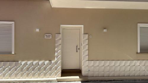 a front door of a house with two windows at B&B Villa Soleil in Vibo Valentia