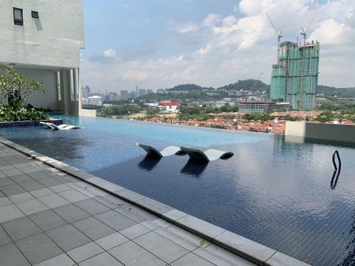 a swimming pool with three dolphins in the water at Desa Park North Ikea One Utama ISP Damansara KL in Kuala Lumpur