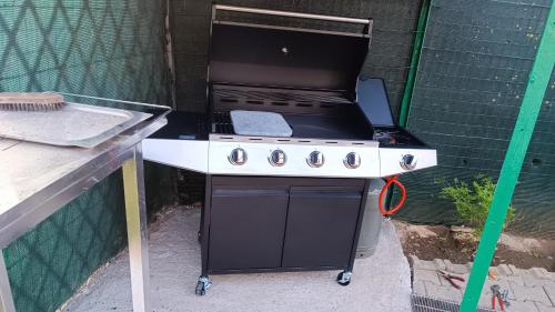 a black and white grill sitting in a backyard at Borgo Foce La Spezia in La Foce