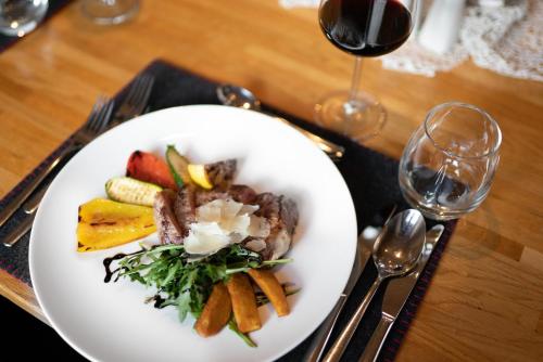 a plate of food with vegetables and meat on a table at Hotel Das Lisann in Pfelders