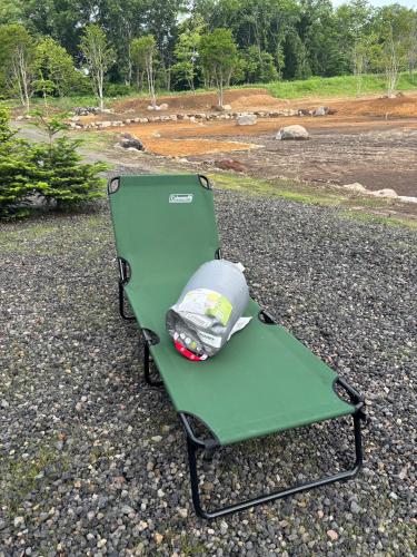 a green folding chair with a trash bag on it at Kita Karuizawa Morino Takibi Pool Villa with Sauna in Tsumagoi