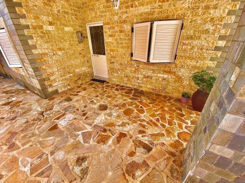 a room with a stone floor and a brick wall at Janos Seaview House in Pentati