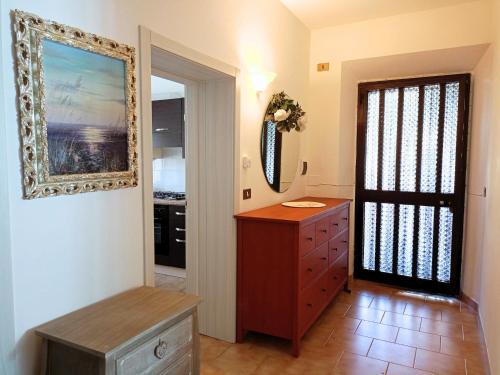 a room with a dresser and a painting on the wall at SE115 - Marotta, delizioso bilocale con posto auto in Marotta