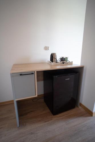 a desk in a room with a black microwave at Pokoje Gościnne Fuksja in Nowęcin