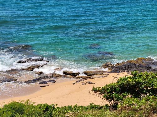 a beach with rocks and the ocean at Stunning Oceanfront Condo - The Seashore Hideaway, Wailua Bay View, Unit 208, Kapaa in Kapaa