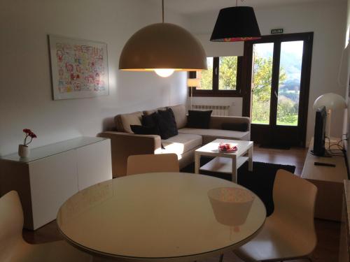 a living room with a table and a couch at Casa Rural Balerdi in Azcárate