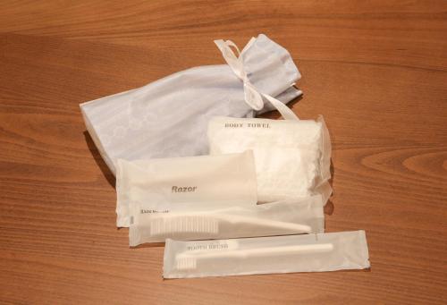 two white plastic bags sitting on a wooden table at ROMANSTAY in Takayama