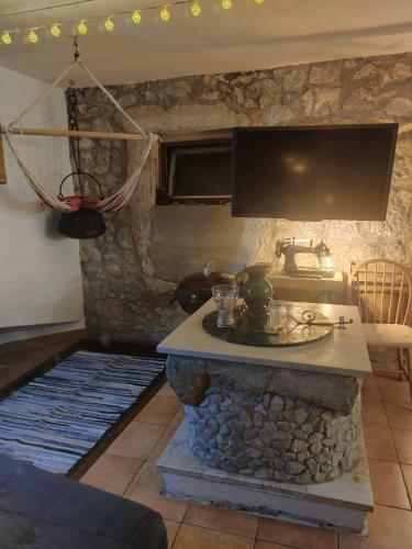 a living room with a stone fireplace with a tv at Appartement Balthasar - Turm Krk in Sveti Vid-Miholjice