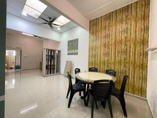 a dining room with a table and chairs at 3 rooms Town Homestay 1 mins to Town in Teluk Intan