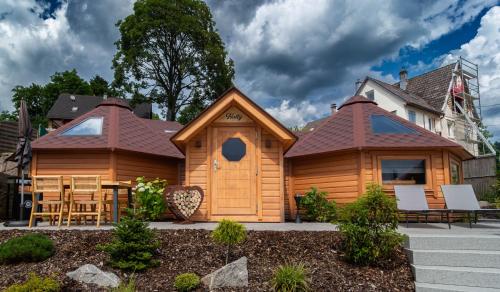 a log cabin with a pitched roof at Les Kotas du bonheur in Soultzeren