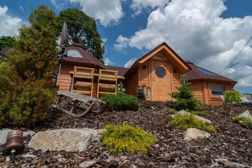 a log cabin with a bench in front of it at Les Kotas du bonheur in Soultzeren