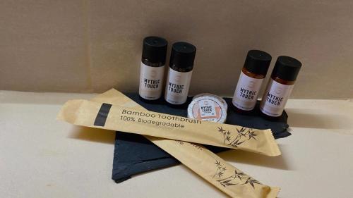 a group of four bottles ofodorizers sitting on a table at Babatseratsi skyrian studio 1 in Skiros