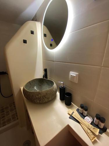 a bathroom with a sink and a mirror on a counter at Babatseratsi skyrian studio 1 in Skiros