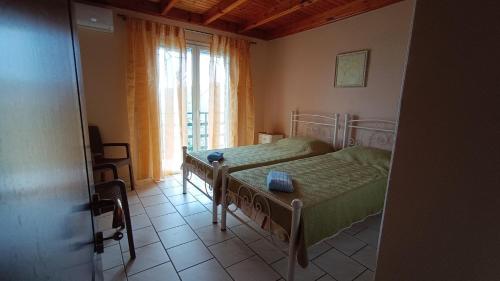 a bedroom with a bed and a window at Spiti TRIVIZAS in Agrós