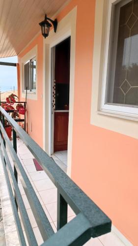 a front porch of a house with a window at Spiti TRIVIZAS in Agrós