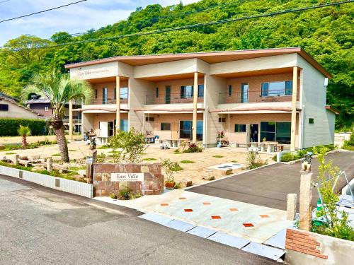 a large house in the middle of a street at East Villa Shimanami Mukaishima seafront in Onomichi