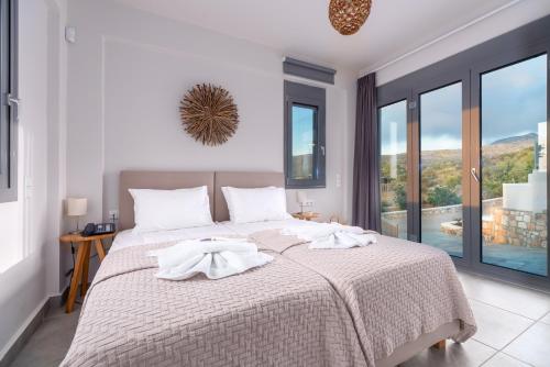 a bedroom with a large bed with towels on it at Elafonisos Aqua Villa I in Elafonisos