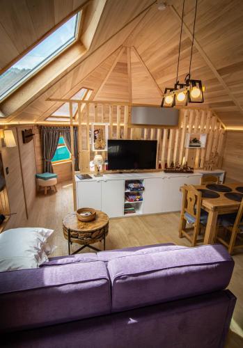 a living room and kitchen in a tiny house at Les Kotas du bonheur in Soultzeren