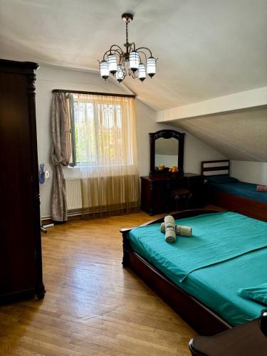 a bedroom with a green bed and a large window at california hostel in Yerevan