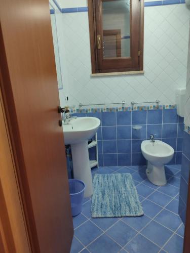 a bathroom with a sink and a toilet at Appartamenti Za Barbara in Lampedusa