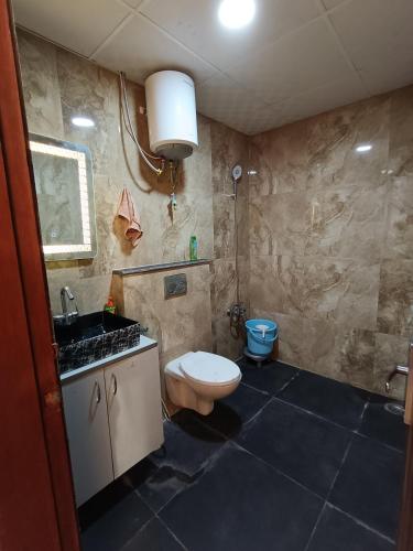 un baño con inodoro y lavabo en Couple Friendly#Darshana Studios, en Noida