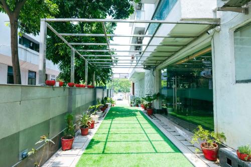 a greenhouse with plants on the side of a building at Treebo Sunny Feast in Greater Noida