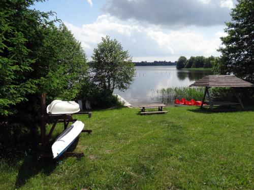 a picnic area with a gazebo and a lake at AgroGabi - Wypoczynek na Podlasiu in Burniszki