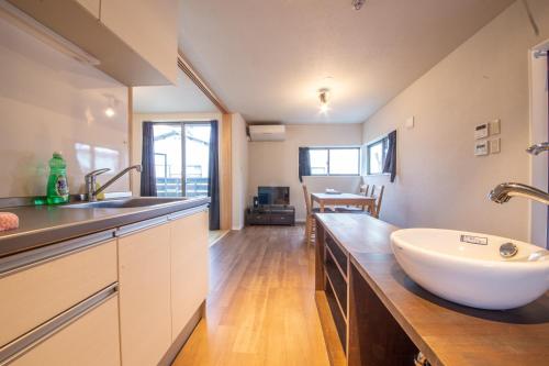 a large bathroom with a sink and a counter at Life House Tamatsukuri Osaka Castle in Osaka