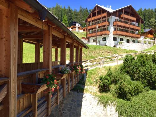a building with flowers on the side of it at RTA Torre Del Brenta in Madonna di Campiglio