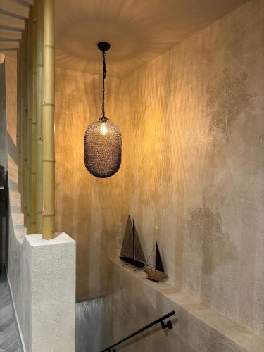 aendant light hanging from a wall with a boat on it at Casa Mint in Sozopol