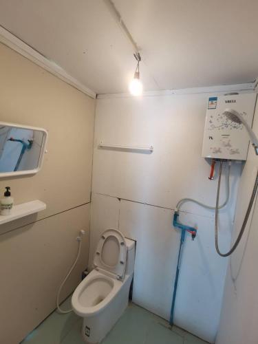 a small bathroom with a toilet and a sink at Panakluea at Kokuang Homestay in Ban Na Lae