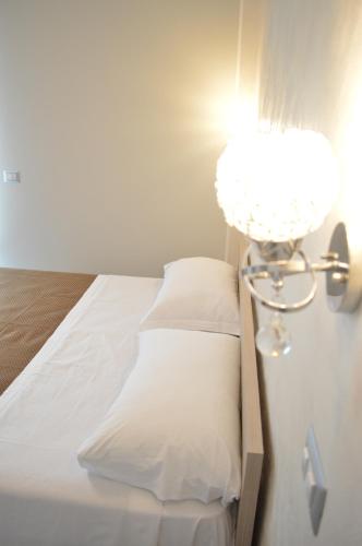 a bedroom with a bed with a lamp on it at Sotto il Cielo del Cilento in Ostigliano