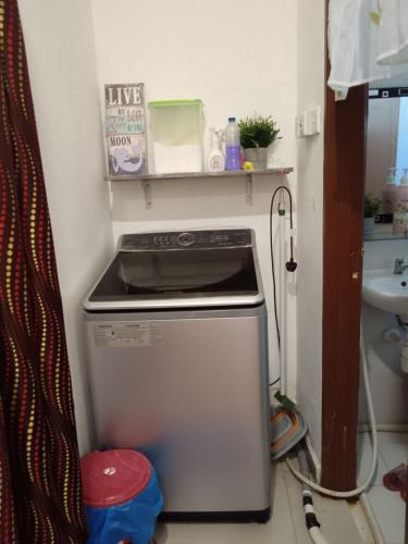 a kitchen with a dishwasher and a sink at Izora Homestay in Kampong Pengkalan Maras