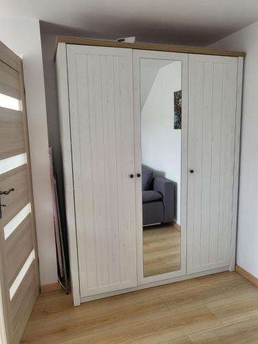 a door with a mirror in a room at Domek pod Hyrką Bieszczady-Lesko in Lesko