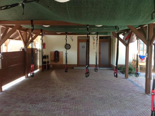 a room with swings hanging from a tent at Öregtölgy Panzio in Csongrád