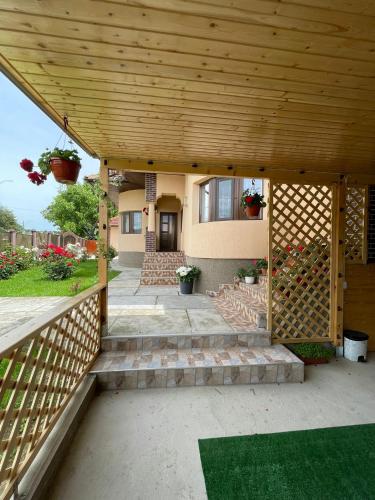 a wooden pergola with stairs leading to a house at Pensiunea CAV in Novaci