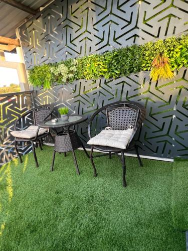a patio with chairs and a table on grass at PROTERM apartments in Timjanik