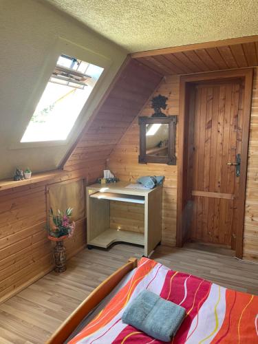 a bedroom with a desk and a bed in a room at Rekreační horská chata na Nové Vsi 90 in Dolní Moravice