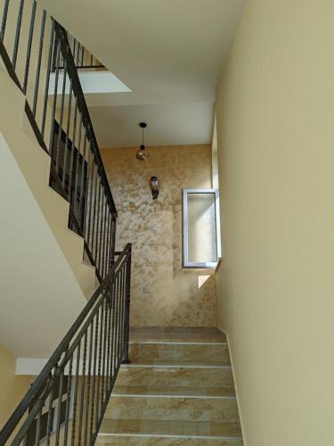 a staircase in a building with a picture on the wall at City Park Rooms in Vranje