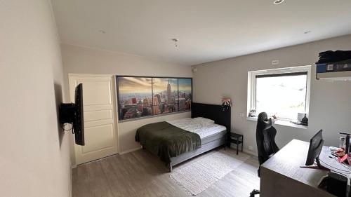 a bedroom with a bed and a window and a desk at Panorama #CasaSolvik #Loen in Loen