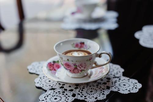 a cup of coffee on a saucer on a table at Moncastro Glamping in Vylkove