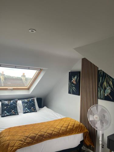 a bedroom with a bed and a window and a fan at Spacious and stylish home Bath in Bath