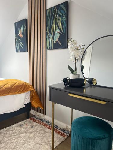 a bedroom with a desk with a mirror and a bed at Spacious and stylish home Bath in Bath